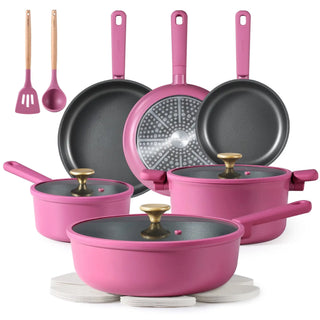 Modern kitchen cookware set including non-stick pots, frying pans, lids, and utensils on a stovetop and counter